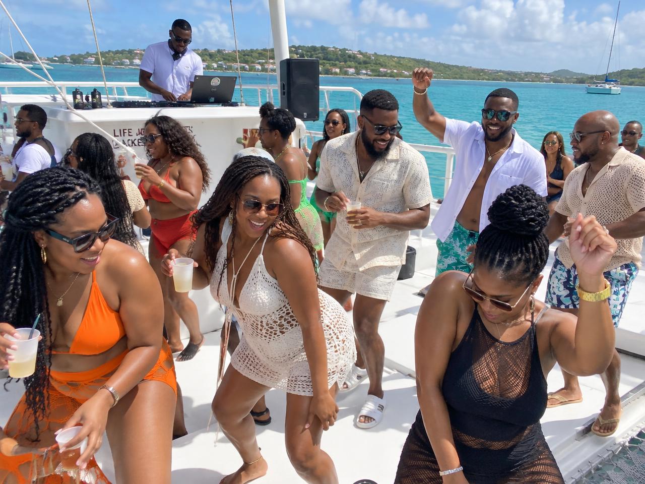 Men enjoying a hip-hop boat party on Caribbean water